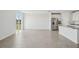 Open-concept living room featuring wood-look tile floors and stainless steel appliances at 31647 Malbec Dr, Brooksville, FL 34602