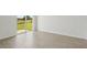 Bright room with wood-look tile floors and sliding glass door access to outdoor at 31647 Malbec Dr, Brooksville, FL 34602