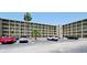 Exterior view of a well-maintained apartment complex with ample parking and lush landscaping at 3534 Lake Bayshore Dr # 118, Bradenton, FL 34205