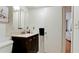Compact bathroom with a dark vanity, toilet and lighting with view of the bedroom at 3534 Lake Bayshore Dr # 118, Bradenton, FL 34205
