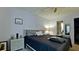 Cozy bedroom boasts a ceiling fan and a wicker nightstand, complemented by a stylish bed at 3534 Lake Bayshore Dr # 118, Bradenton, FL 34205