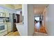 Hallway leading to the kitchen and living room area with hardwood floors, tile flooring, and neutral walls at 3534 Lake Bayshore Dr # 118, Bradenton, FL 34205