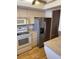 Kitchen featuring stainless steel refrigerator and view into adjacent dining area at 3534 Lake Bayshore Dr # 118, Bradenton, FL 34205