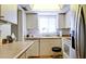 Well-lit kitchen with white cabinetry, stainless steel appliances, laminate countertop, and a window above the sink at 3534 Lake Bayshore Dr # 118, Bradenton, FL 34205