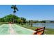 Scenic lake view showcasing the shuffleboard court and benches in a waterfront setting at 3534 Lake Bayshore Dr # 118, Bradenton, FL 34205