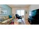 Comfortable living room featuring a sofa, recliner, television and sliding glass doors to the exterior at 3534 Lake Bayshore Dr # 118, Bradenton, FL 34205