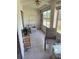 Relaxing enclosed sunroom featuring tile floors, a ceiling fan, and views of the outdoors at 3534 Lake Bayshore Dr # 118, Bradenton, FL 34205