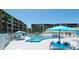 Bright outdoor community pool with umbrellas and seating, perfect for relaxation at 3534 Lake Bayshore Dr # 118, Bradenton, FL 34205