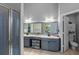 Bathroom featuring double sink vanity, shower with glass door, and separate toilet room at 3703 Treeline Dr, Valrico, FL 33596