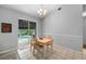 Cozy dining area featuring tile floors and sliding glass doors leading to the screened-in pool at 3703 Treeline Dr, Valrico, FL 33596