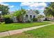 Landscaped home featuring a lush green lawn, mature trees, and inviting curb appeal on a sunny day at 3703 Treeline Dr, Valrico, FL 33596