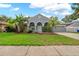 Beautiful home with a well-manicured lawn, lush landscaping, and an inviting facade under a sunny sky at 3703 Treeline Dr, Valrico, FL 33596