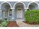 Charming entryway with arched accents and lush plants, creating a welcoming first impression at 3703 Treeline Dr, Valrico, FL 33596