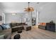 Open-concept living room with wood floors, neutral walls, couch, and view of the kitchen at 3703 Treeline Dr, Valrico, FL 33596
