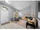 Inviting living room with tile and wood floors, neutral walls, sofa set, and large windows at 3703 Treeline Dr, Valrico, FL 33596