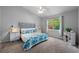 Cozy main bedroom with a wooden bed, carpeted floors, neutral walls, large window, and a ceiling fan at 3703 Treeline Dr, Valrico, FL 33596