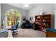 Well-lit office space with large arched window and carpeted floor at 3703 Treeline Dr, Valrico, FL 33596