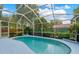 Sparkling pool with a screened enclosure, surrounded by lush landscaping and offering a private oasis at 3703 Treeline Dr, Valrico, FL 33596