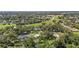 Scenic aerial view of a home close to a highway, complemented by mature trees and a well-manicured green lawn at 37309 Fountain Rd, Zephyrhills, FL 33542