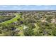 Beautiful aerial shot of a home on a large lot featuring lush trees, spacious green lawns and distant highway views at 37309 Fountain Rd, Zephyrhills, FL 33542
