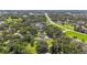 Panoramic aerial shot of a home and the surrounding area, featuring mature trees, a pool, and nearby highway at 37309 Fountain Rd, Zephyrhills, FL 33542