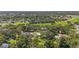 An aerial view showing the neighborhood's proximity to the highway, lush tree coverage, and spacious green lawns at 37309 Fountain Rd, Zephyrhills, FL 33542