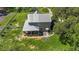 Aerial view of a two-story home with a metal roof, screened porch, and a spacious backyard at 37309 Fountain Rd, Zephyrhills, FL 33542