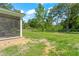 Expansive backyard featuring a screened porch with an outdoor dining area and a well-maintained lawn at 37309 Fountain Rd, Zephyrhills, FL 33542