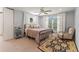 This bedroom features a ceiling fan, seating and a large bright window at 37309 Fountain Rd, Zephyrhills, FL 33542