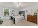 Cozy bedroom with ceiling fan, window, and baseball themed decorations at 37309 Fountain Rd, Zephyrhills, FL 33542