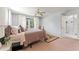 Cozy bedroom with a large window, comfortable bed and doorway to the bathroom at 37309 Fountain Rd, Zephyrhills, FL 33542