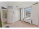 Bright bedroom features carpet, closet, and chest near window for storage at 37309 Fountain Rd, Zephyrhills, FL 33542