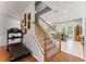 Elegant entryway with stairs, hardwood floors, and views of the dining area and backyard at 37309 Fountain Rd, Zephyrhills, FL 33542