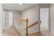 Hallway with wood railing and access to rooms at 37309 Fountain Rd, Zephyrhills, FL 33542