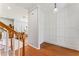 Hallway with hardwood floors, wainscoting, and views to the living room and stairs at 37309 Fountain Rd, Zephyrhills, FL 33542