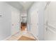 Hallway featuring tile flooring, white walls, storage, and access to the dining room at 37309 Fountain Rd, Zephyrhills, FL 33542