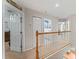 Upstairs hallway shows doors to bedrooms and bathrooms with carpeted floor at 37309 Fountain Rd, Zephyrhills, FL 33542
