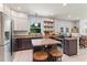 Updated kitchen with stainless steel appliances, white cabinets, granite countertops, and a center island at 37309 Fountain Rd, Zephyrhills, FL 33542