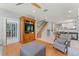 Open-concept living space with hardwood floors, built-in shelving, and staircase to the second floor at 37309 Fountain Rd, Zephyrhills, FL 33542
