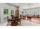 Open-concept living room flows from dining area, bathed in light with outdoor views at 37309 Fountain Rd, Zephyrhills, FL 33542