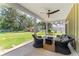 View of porch with wicker seating and view of the backyard at 37309 Fountain Rd, Zephyrhills, FL 33542