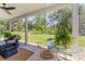 View of outdoor porch seating and large landscaped backyard at 37309 Fountain Rd, Zephyrhills, FL 33542