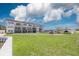 Exterior view of the condo building with a grassy area and assigned parking at 3789 46Th S Ave # 204, St Petersburg, FL 33711