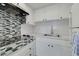 Efficient white kitchen with modern backsplash and stainless steel sink at 3789 46Th S Ave # 204, St Petersburg, FL 33711