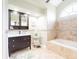 Updated bathroom featuring a vanity, soaking tub, and ceramic tile flooring at 382 Florian Way, Spring Hill, FL 34609