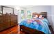Bedroom with hardwood floors, a large dresser, and natural light streaming in from the windows at 382 Florian Way, Spring Hill, FL 34609