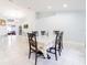 Large dining room with bright light and decorative table set for 6 at 382 Florian Way, Spring Hill, FL 34609