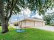 Well-kept front yard with a charming swing, creating a welcoming and playful atmosphere at 382 Florian Way, Spring Hill, FL 34609