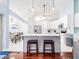 Bright, airy kitchen with white cabinets, a center island, and a view into the adjacent dining area at 382 Florian Way, Spring Hill, FL 34609