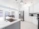 Renovated kitchen features white cabinets, stainless appliances, and a breakfast bar at 382 Florian Way, Spring Hill, FL 34609